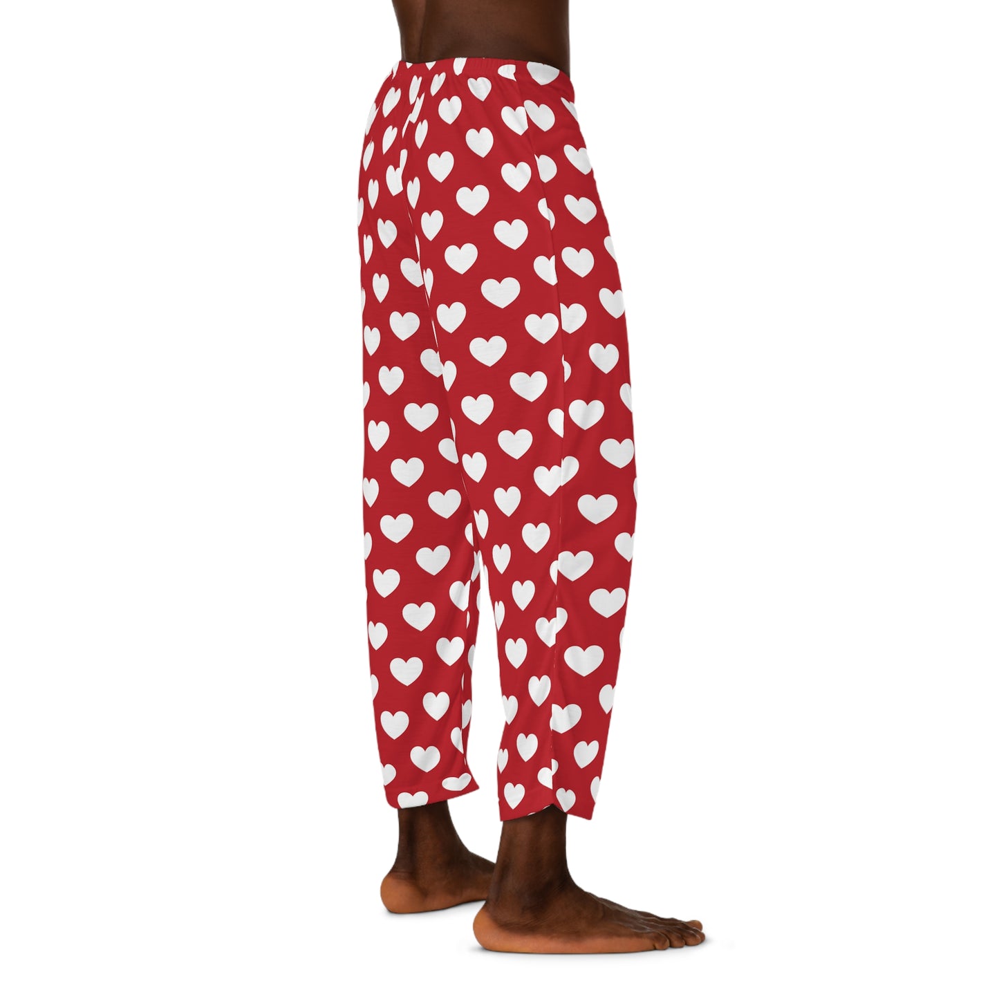 Red pajama bottoms with an all-over print of white hearts, complete with a comfortable black tie at the waist for adjustment