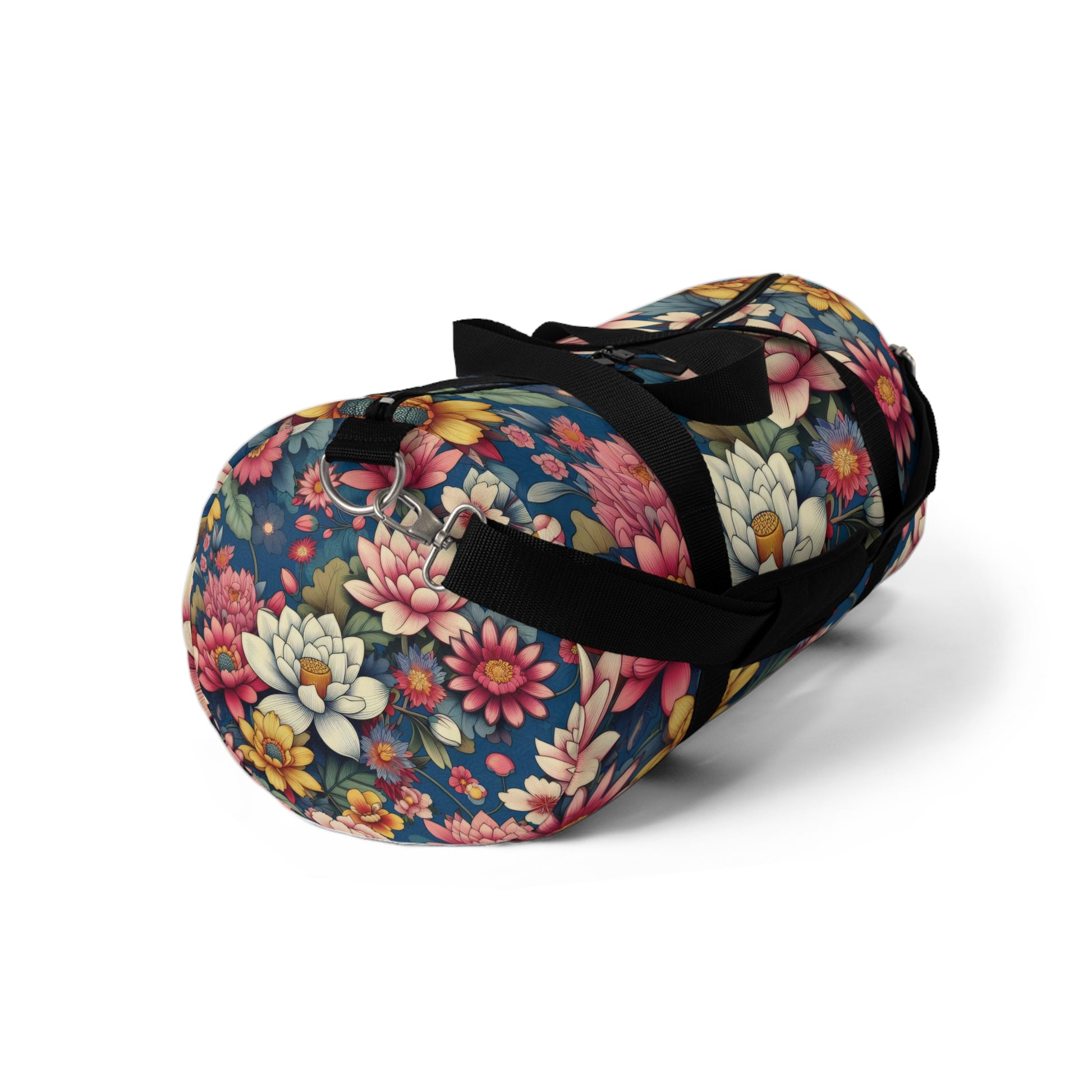 The image depicts a cylindrical duffel bag with a colorful floral pattern and a black shoulder strap.