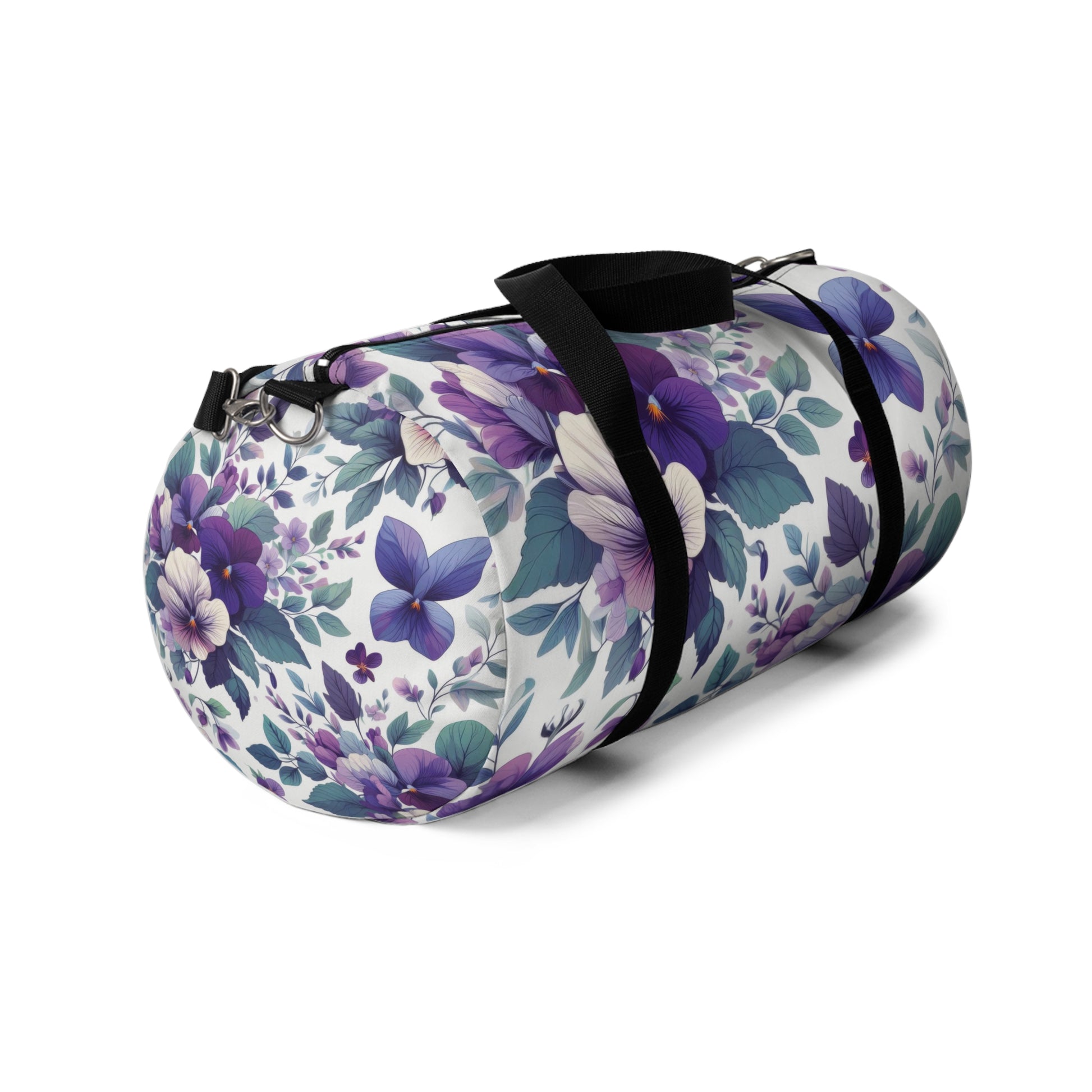 The image shows a cylindrical duffel bag with a floral pattern, featuring a variety of purple flowers and green leaves, complete with black straps for carrying