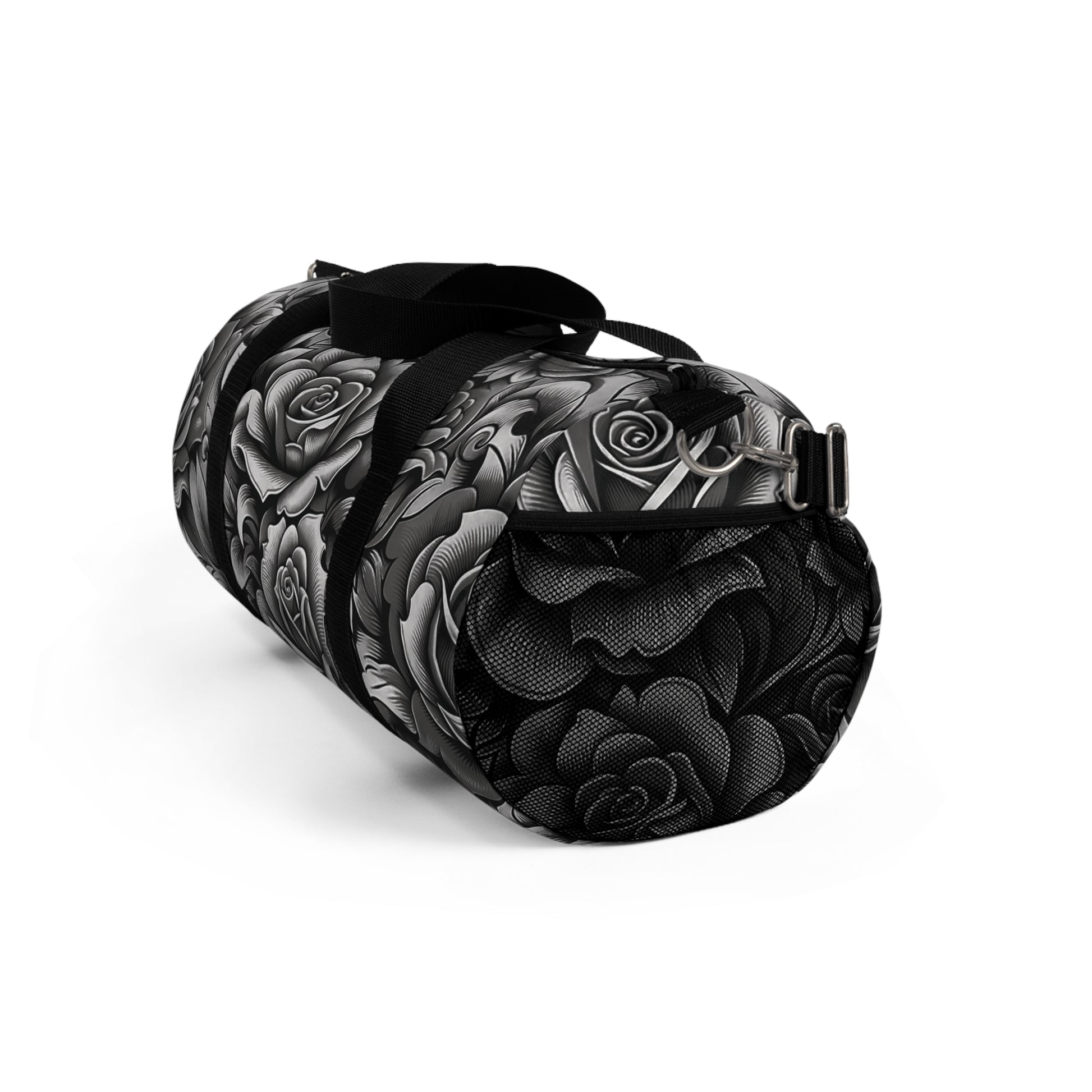 A duffel bag with a monochromatic rose pattern and a black strap.