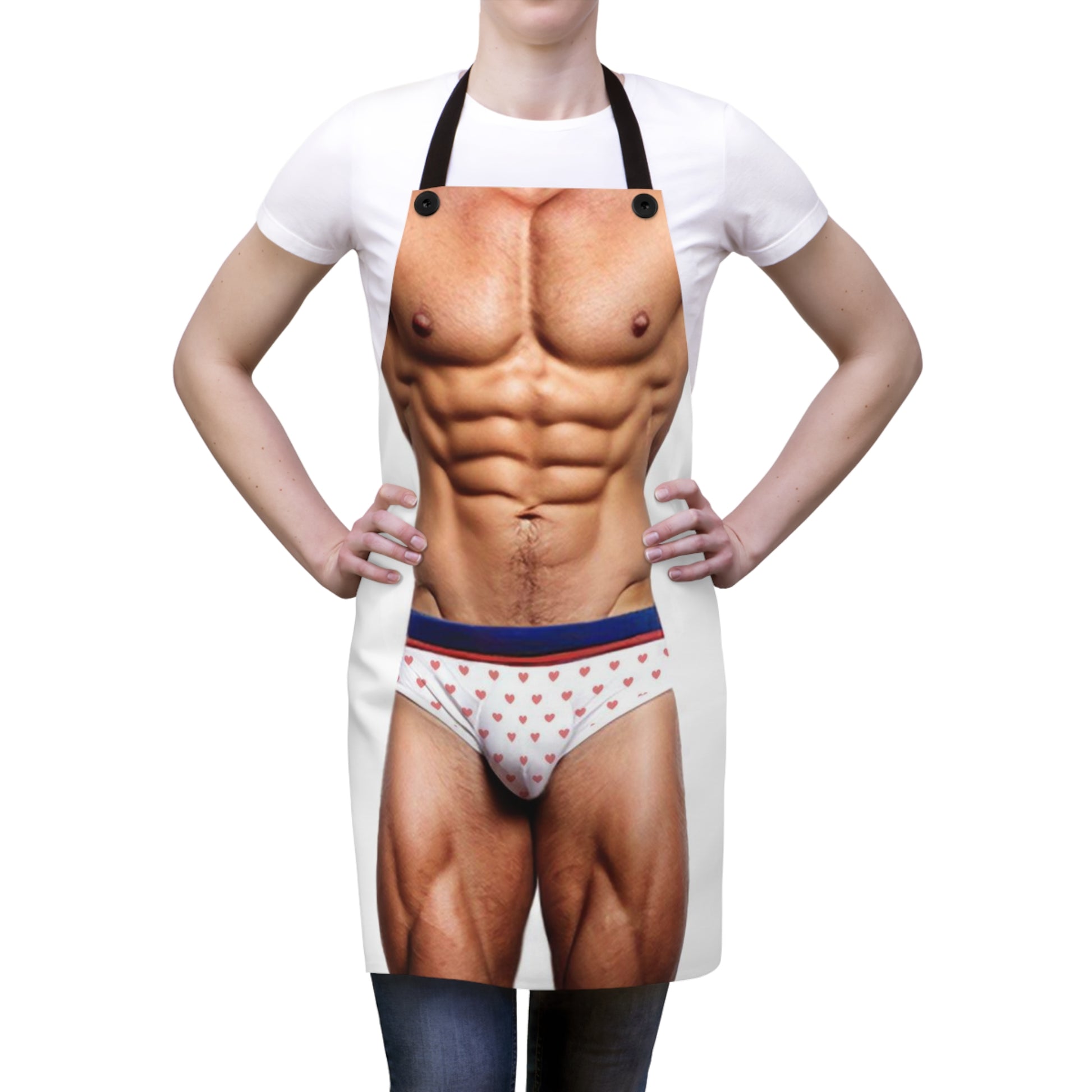 A novelty apron designed to appear as a muscular male torso wearing white briefs with a red heart pattern