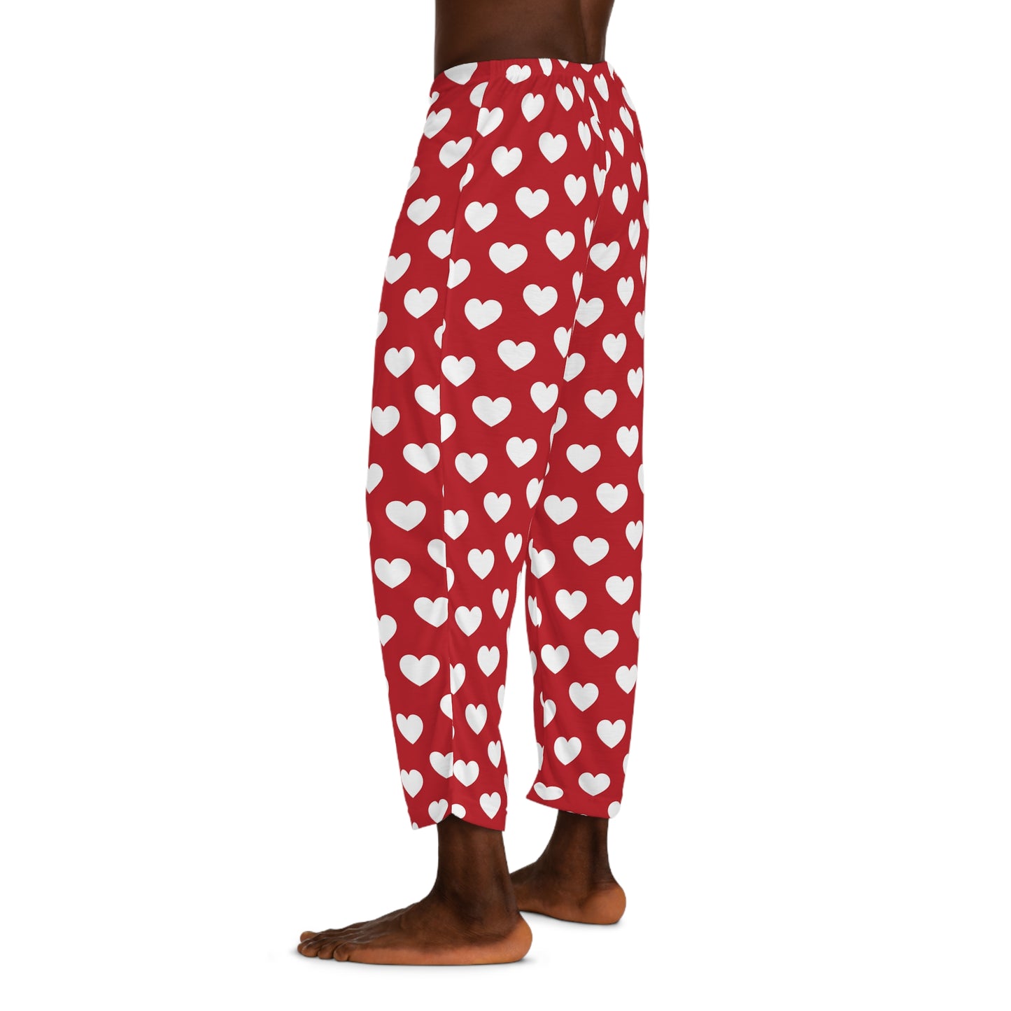 Red pajama bottoms with an all-over print of white hearts, complete with a comfortable black tie at the waist for adjustment