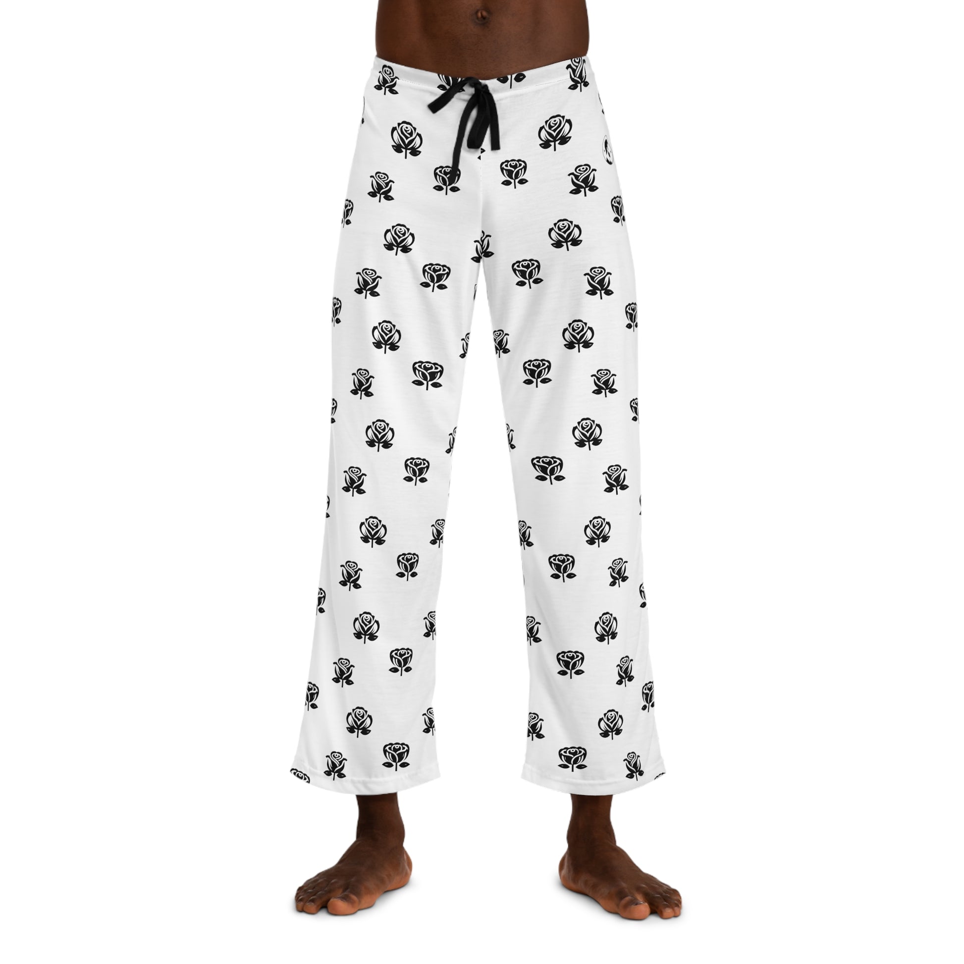 Casual white pajama bottoms decorated with an all-over black rose print, and a contrasting black drawstring at the waist