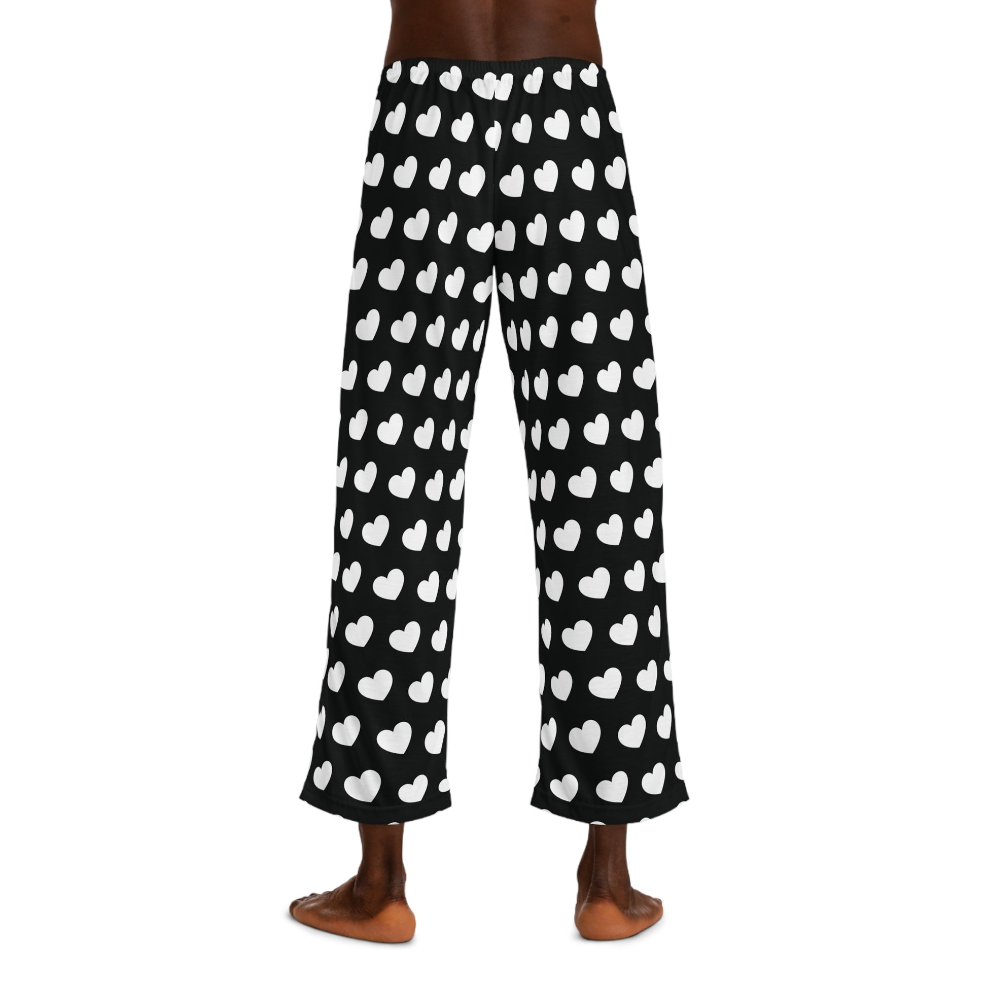 Black pajama pants with a white heart pattern and a drawstring waist.