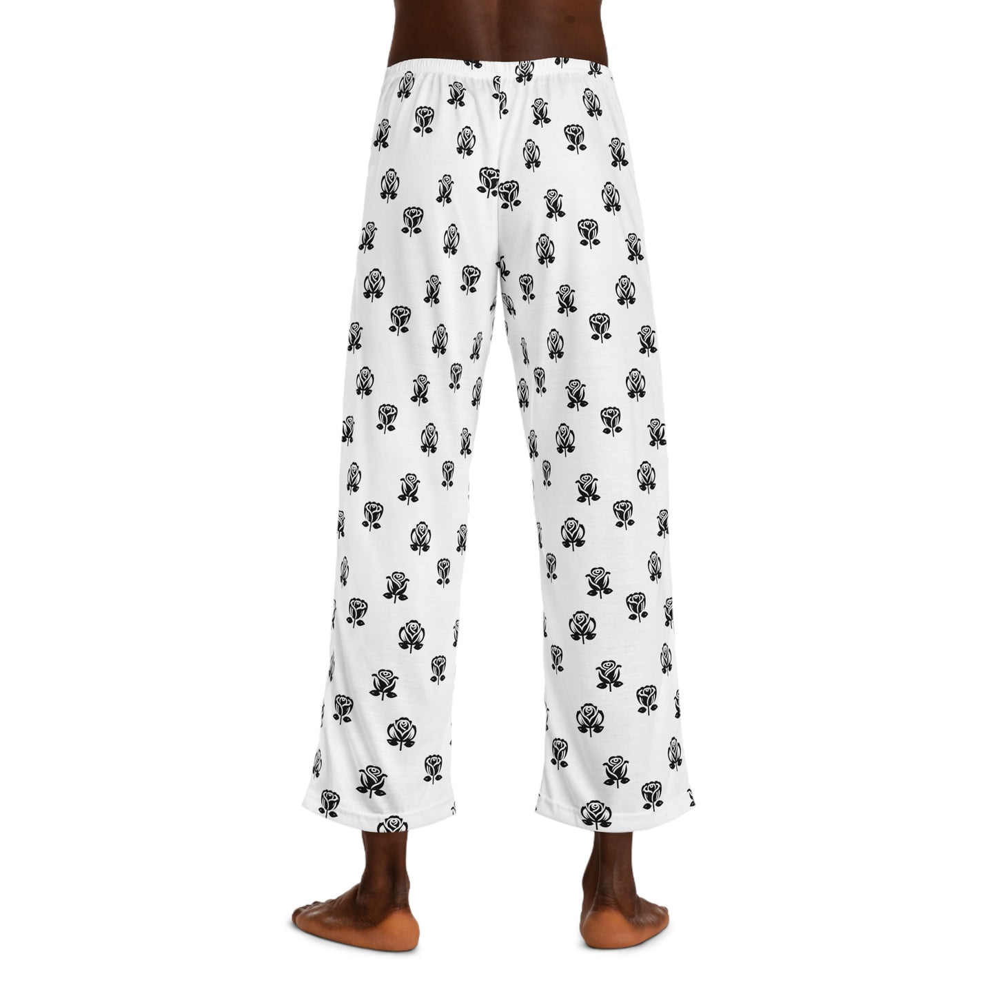Casual white pajama bottoms decorated with an all-over black rose print, and a contrasting black drawstring at the waist