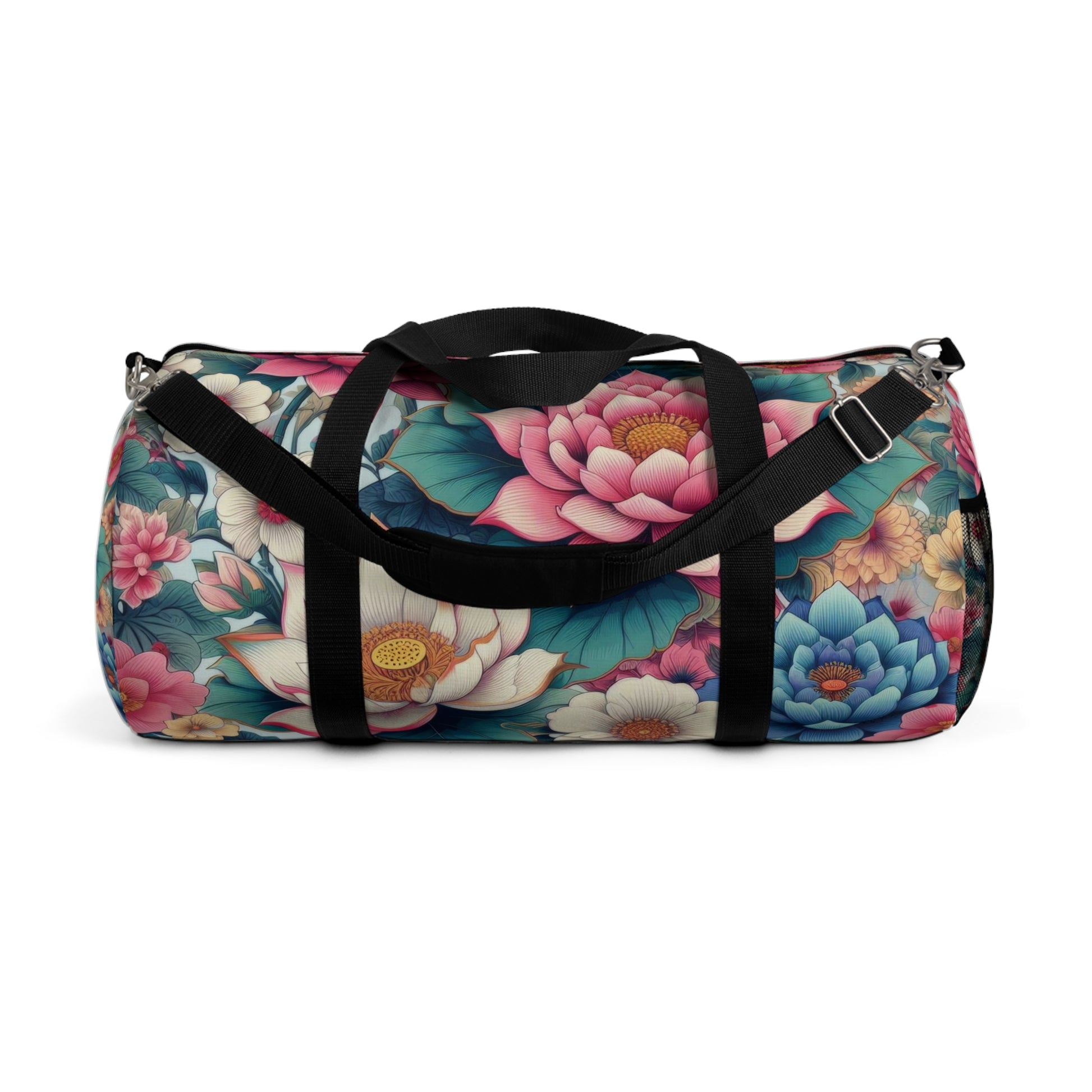 A duffel bag with a vibrant floral pattern featuring large blooms in shades of pink, blue, and white, with green foliage, all set against a dark background. The bag has a black adjustable shoulder strap and black zippers.