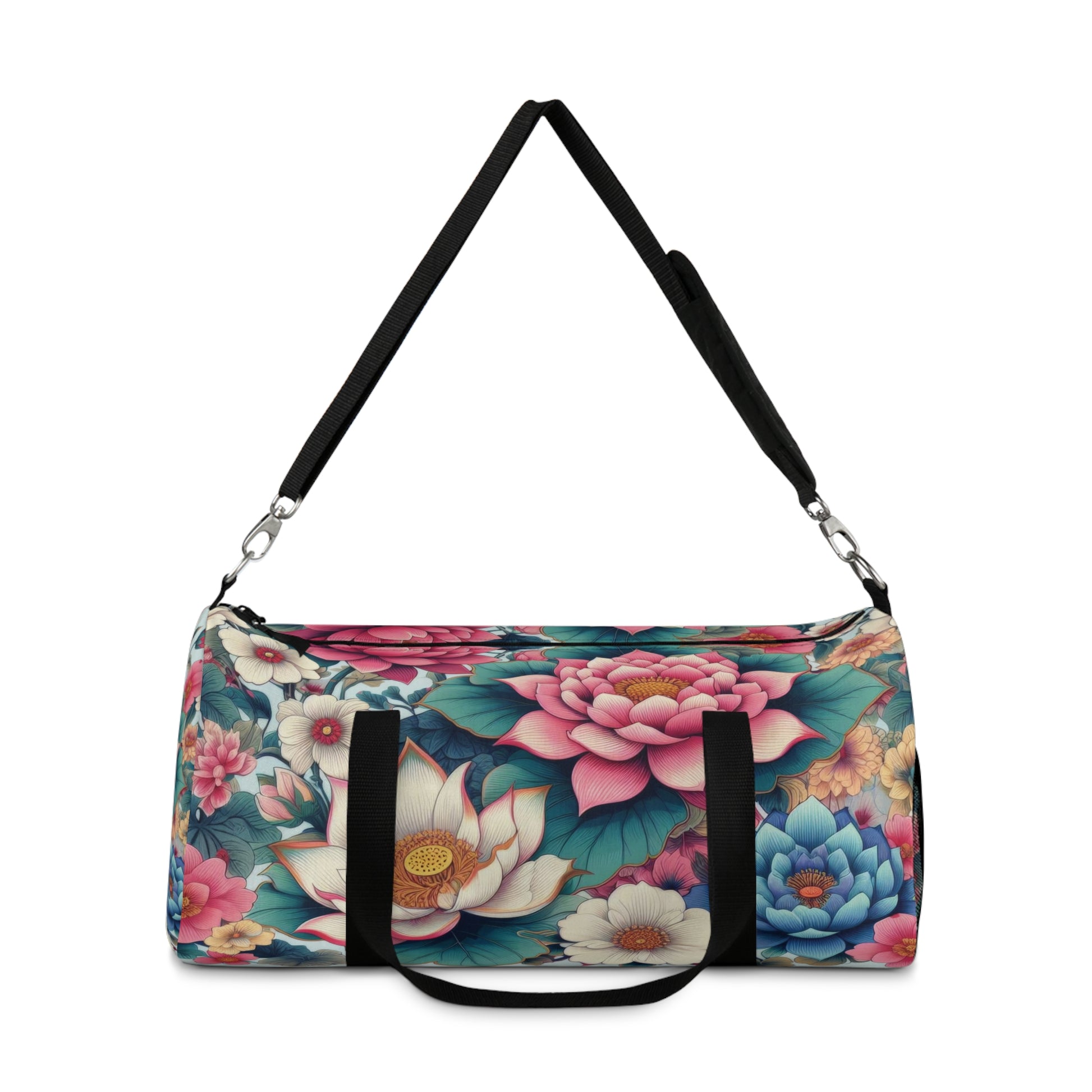 A duffel bag with a vibrant floral pattern featuring large blooms in shades of pink, blue, and white, with green foliage, all set against a dark background. The bag has a black adjustable shoulder strap and black zippers.