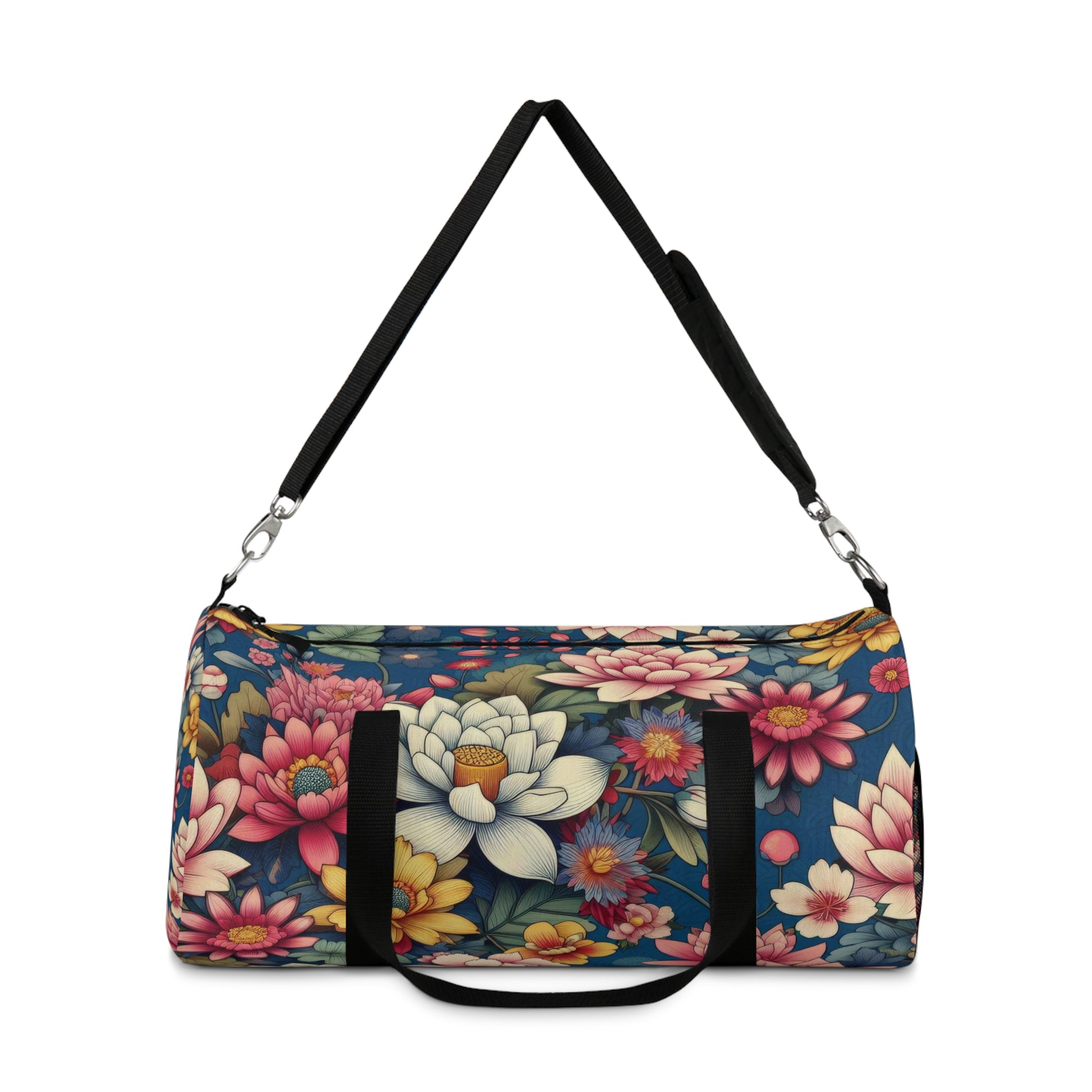 The image depicts a cylindrical duffel bag with a colorful floral pattern and a black shoulder strap.