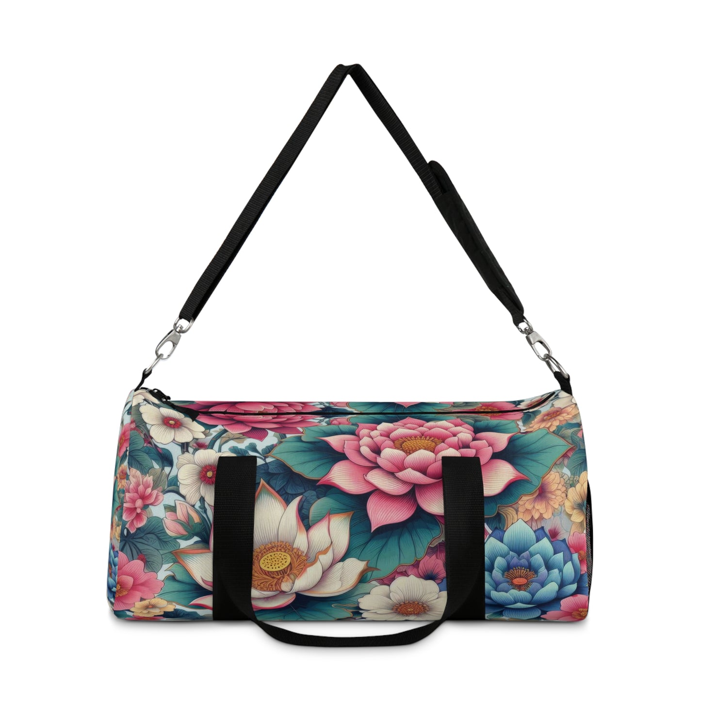 A duffel bag with a vibrant floral pattern featuring large blooms in shades of pink, blue, and white, with green foliage, all set against a dark background. The bag has a black adjustable shoulder strap and black zippers.