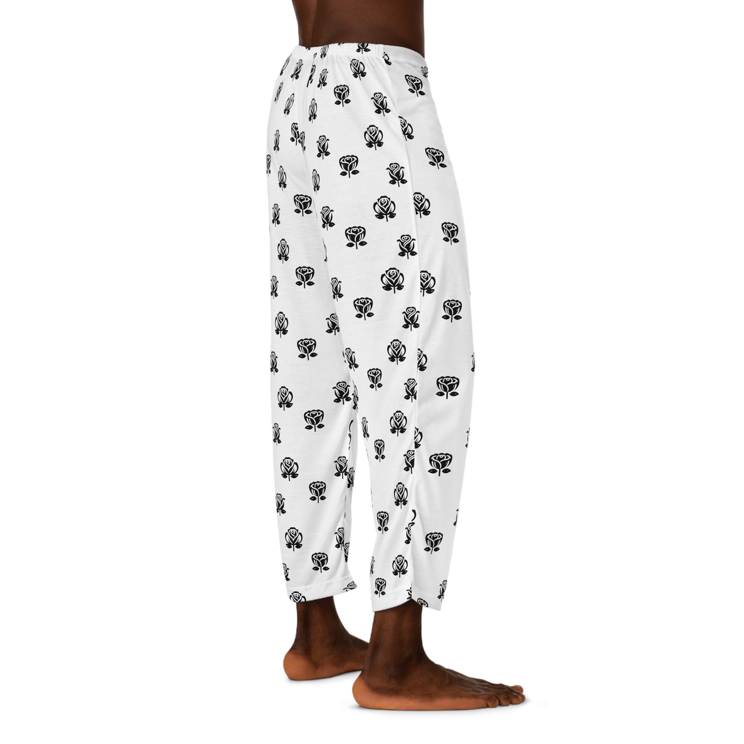 Casual white pajama bottoms decorated with an all-over black rose print, and a contrasting black drawstring at the waist