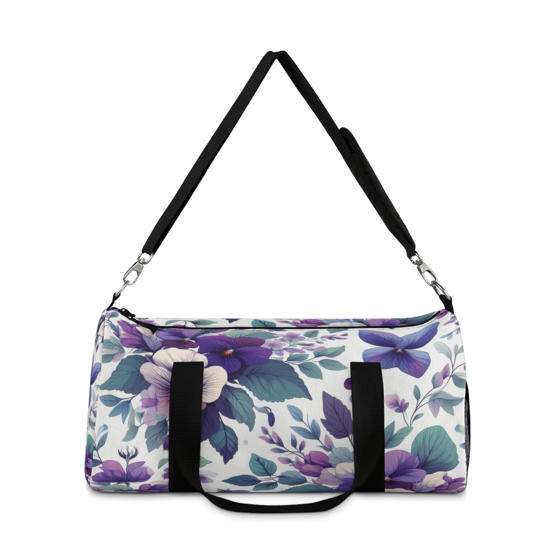 The image shows a cylindrical duffel bag with a floral pattern, featuring a variety of purple flowers and green leaves, complete with black straps for carrying