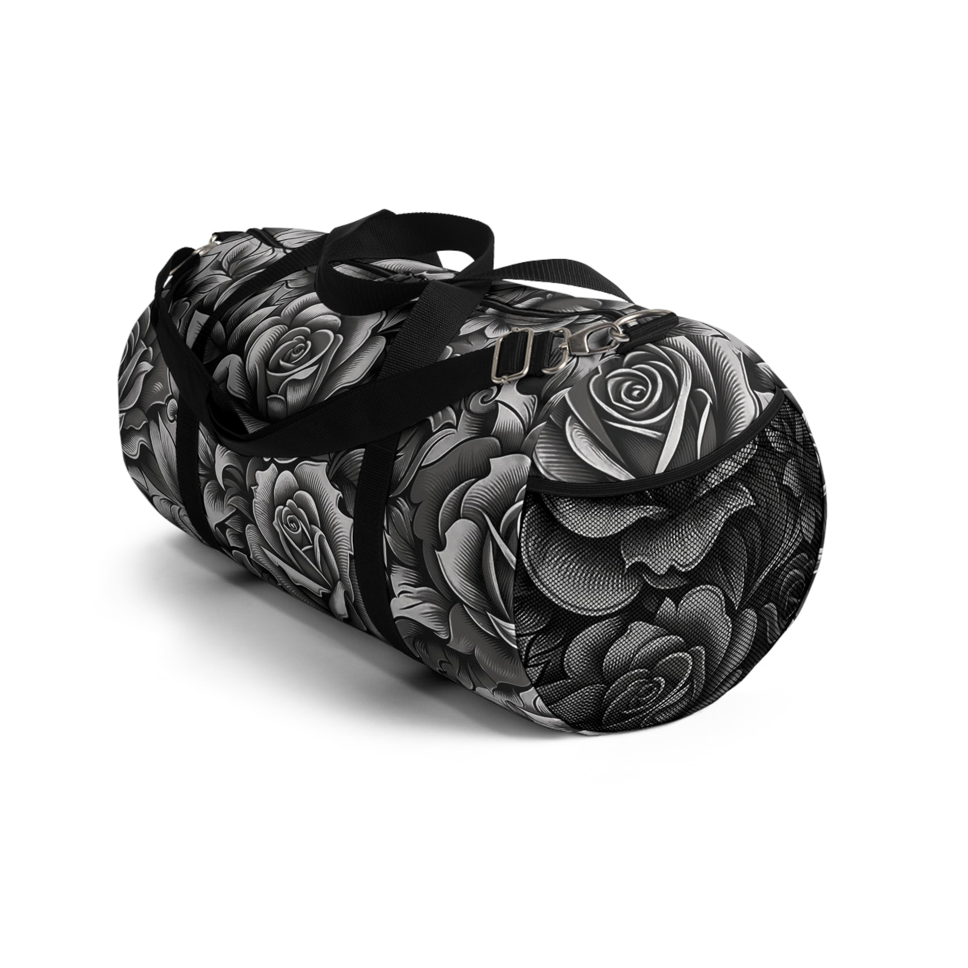 A duffel bag with a monochromatic rose pattern and a black strap.