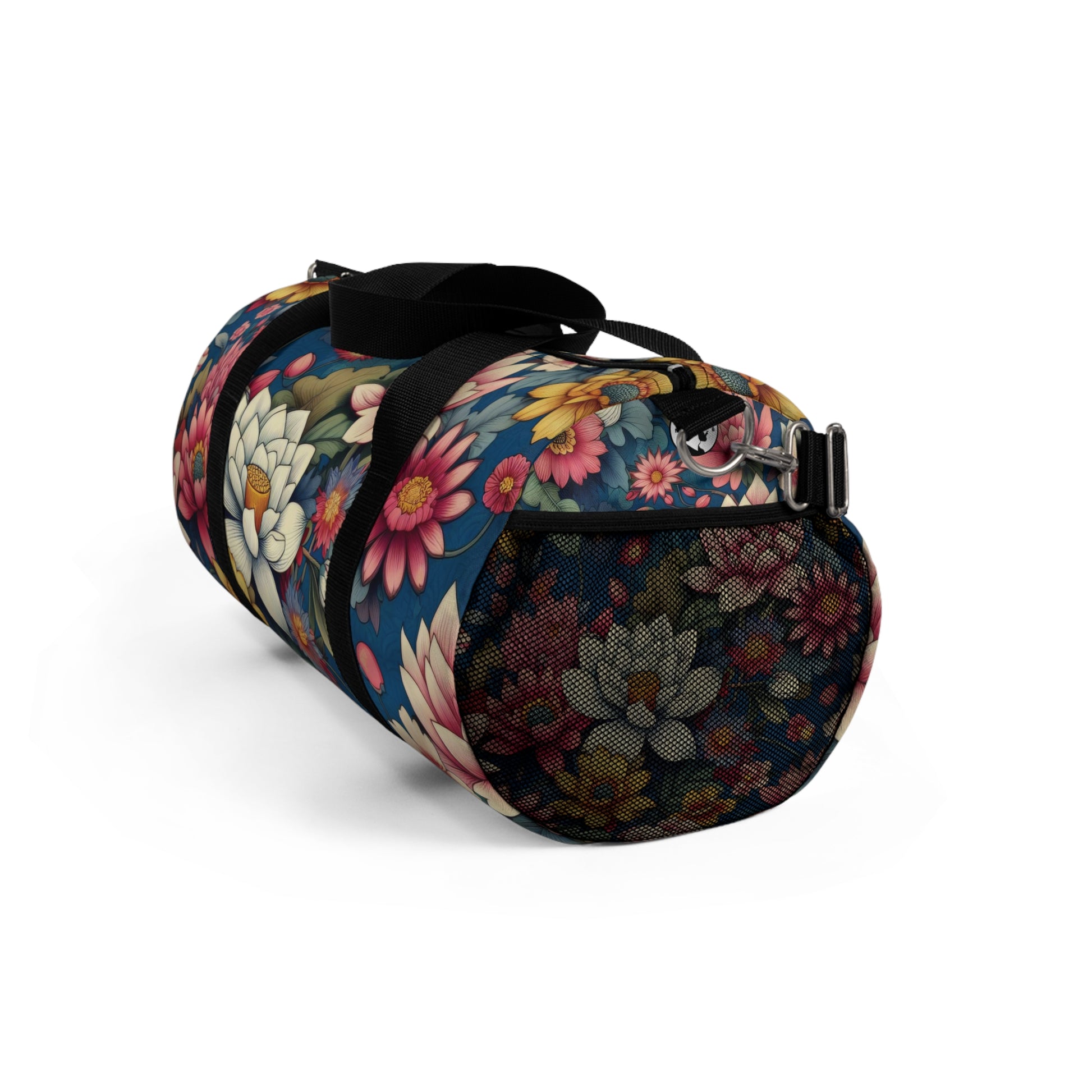 The image depicts a cylindrical duffel bag with a colorful floral pattern and a black shoulder strap.