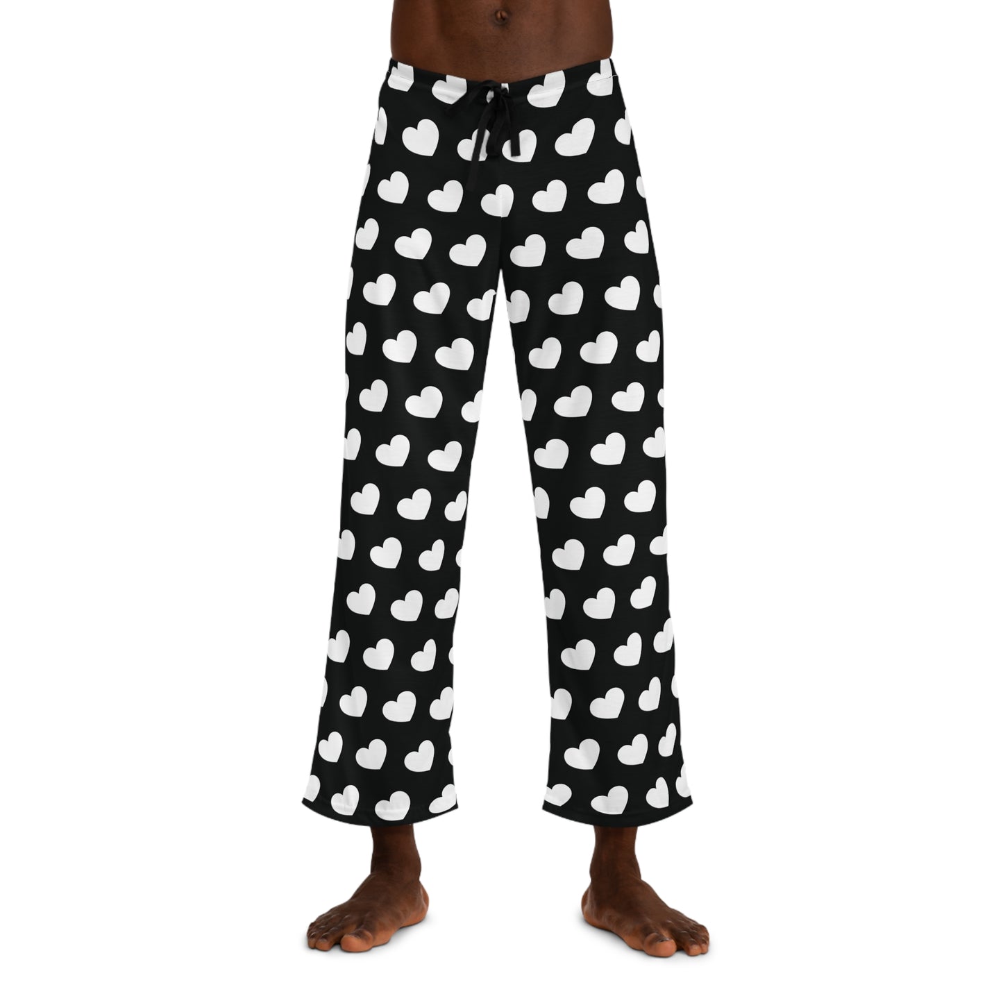 Black pajama pants with a white heart pattern and a drawstring waist.
