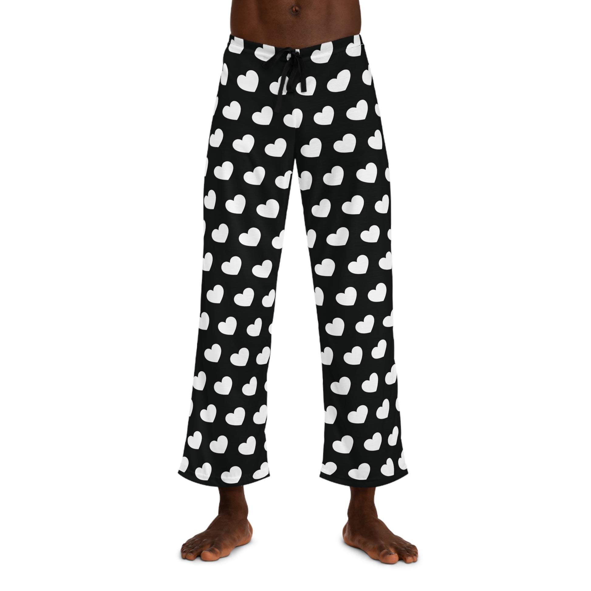 Black pajama pants with a white heart pattern and a drawstring waist.