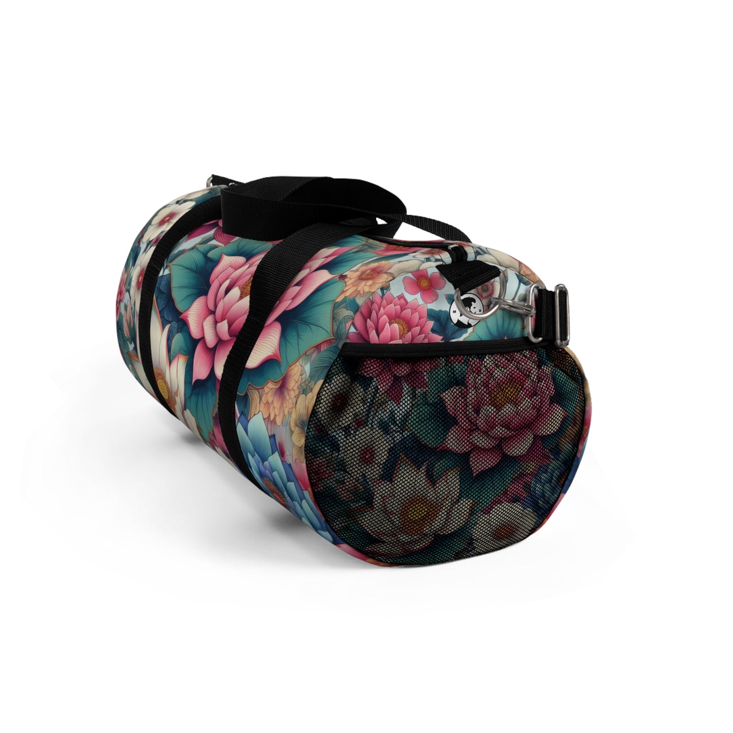 A duffel bag with a vibrant floral pattern featuring large blooms in shades of pink, blue, and white, with green foliage, all set against a dark background. The bag has a black adjustable shoulder strap and black zippers.