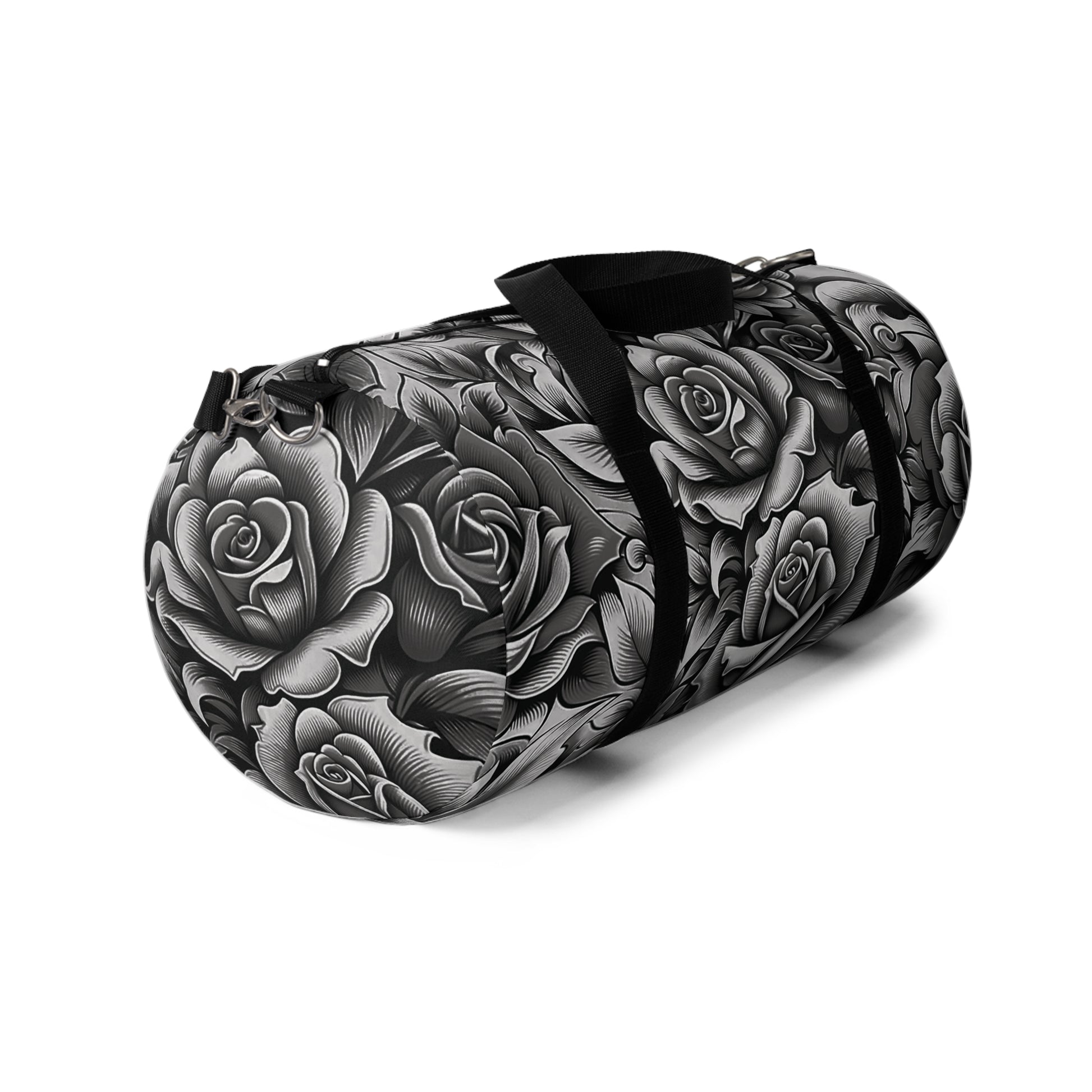 A duffel bag with a monochromatic rose pattern and a black strap.