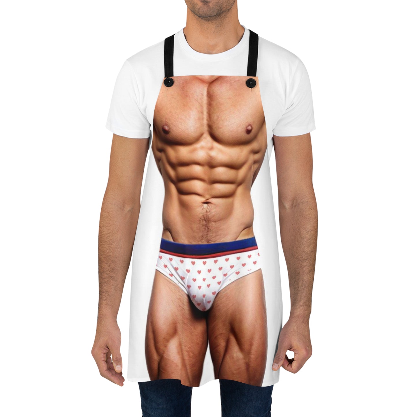 A novelty apron designed to appear as a muscular male torso wearing white briefs with a red heart pattern