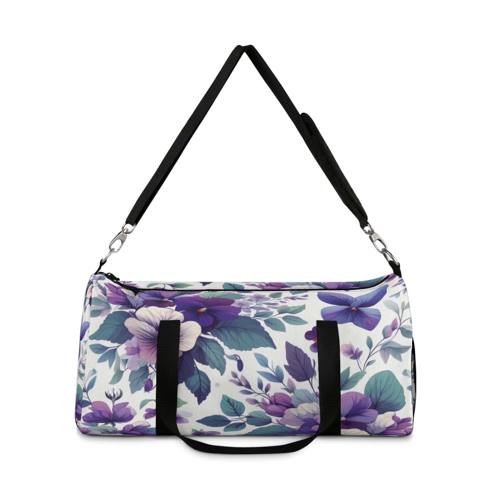 The image shows a cylindrical duffel bag with a floral pattern, featuring a variety of purple flowers and green leaves, complete with black straps for carrying